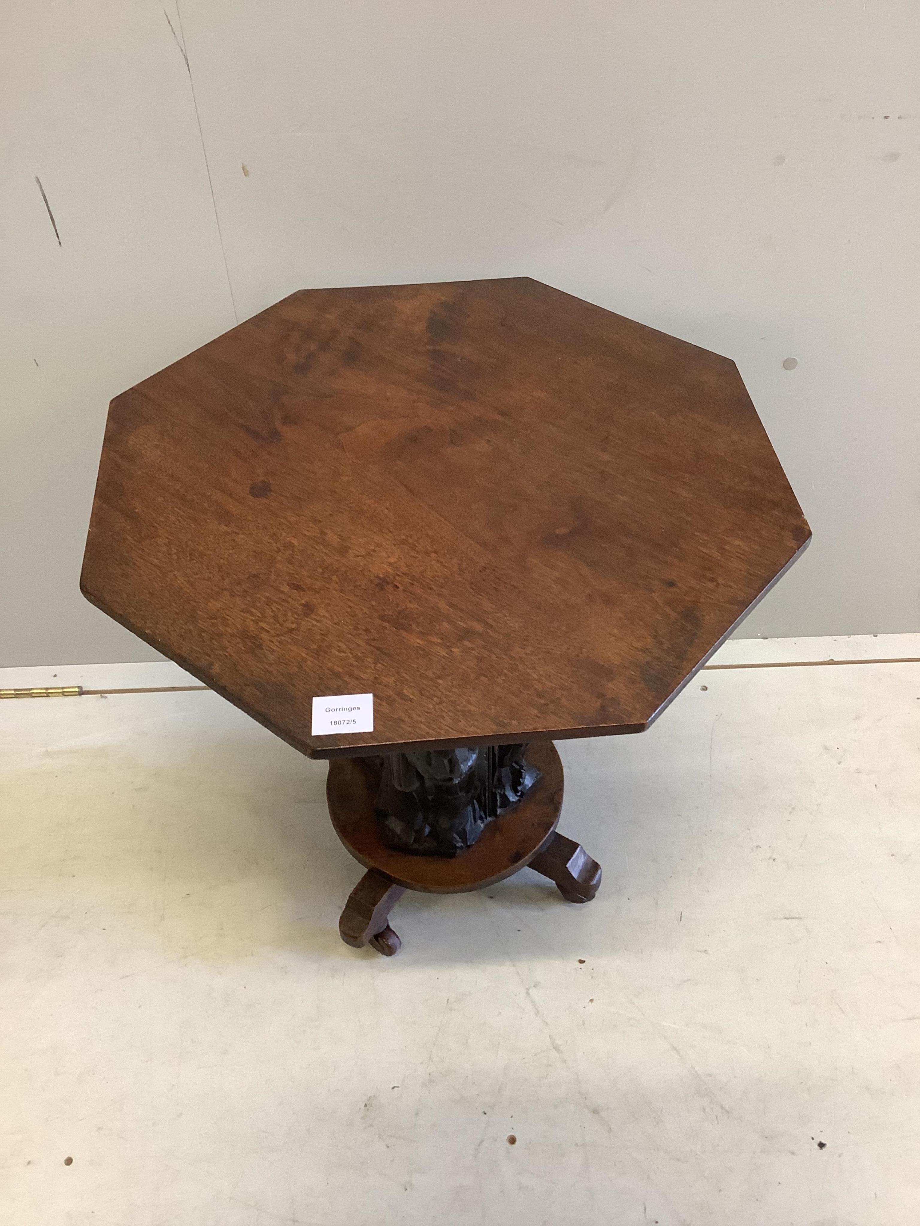 A 19th century octagonal oak side table with figural column, incorporates old timber, width 55cm, depth 55cm, height 59cm